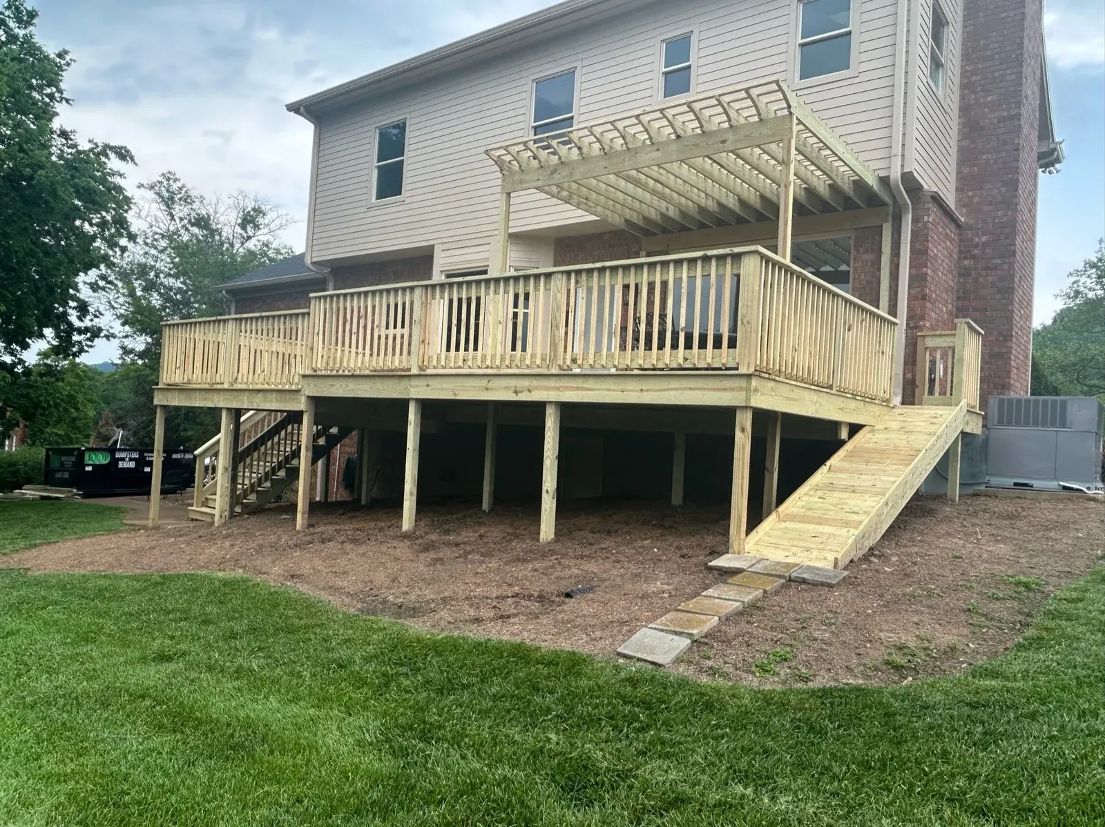 Two-tier pressure-treated deck with a pergola built by Southern Belle Construction on a two-story Tennessee home