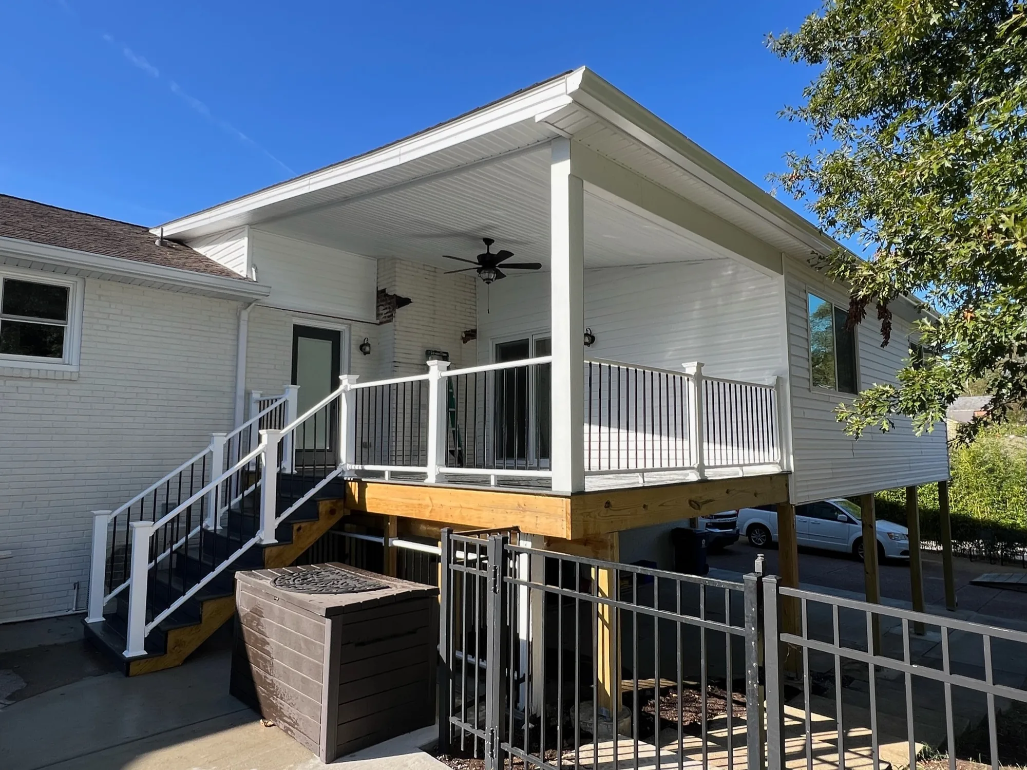 White elevated screened porch with new stairs and railing on a Tennessee home